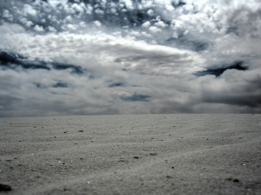 a dark and mysterious sand and sky photo